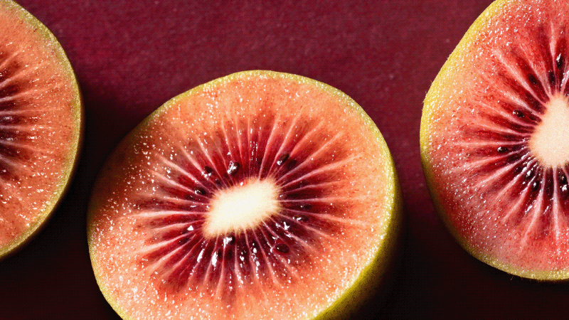 Close up of three pieces of cut Red kiwifruit.